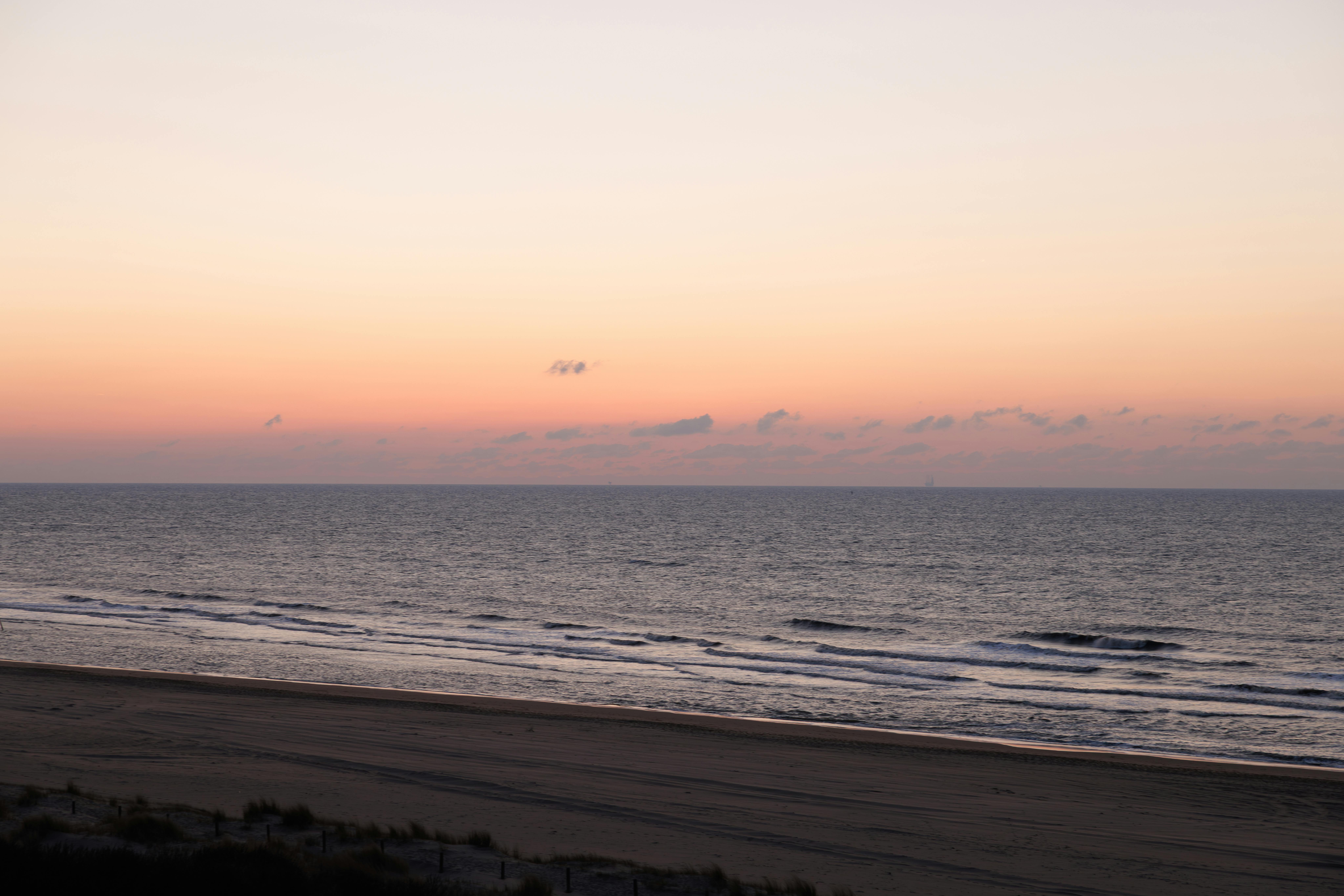 Peaceful sunset over the ocean with gentle waves at Haia beach, Netherlands.