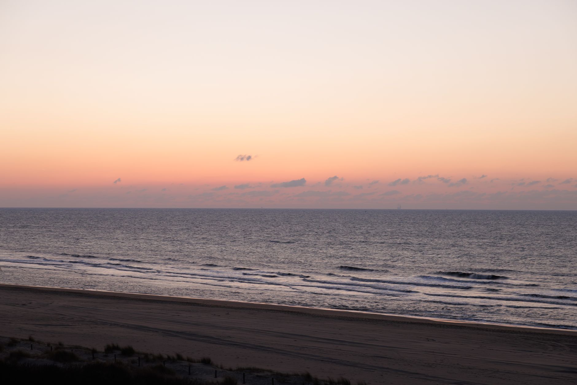 Peaceful sunset over the ocean with gentle waves at Haia beach, Netherlands.