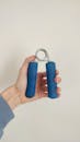 Hand Holding Blue Grip Strength Exercise Tool