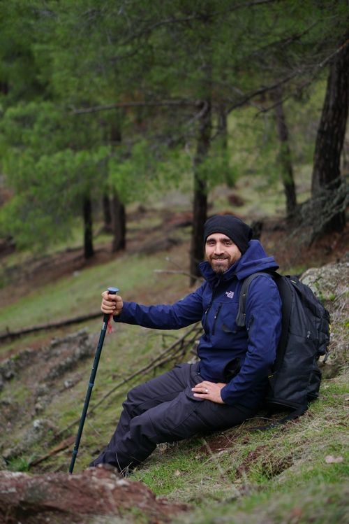 Free A man takes a break during a hiking adventure in the lush forests of Kahramanmaraş, Türkiye. Stock Photo