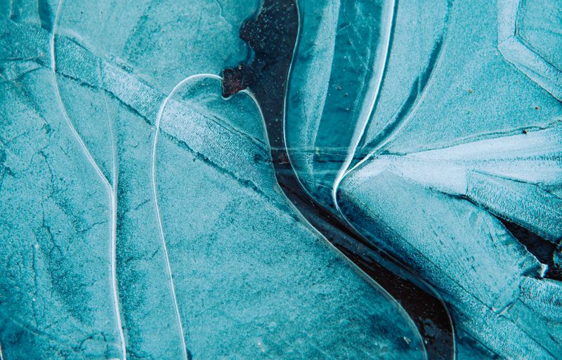 Blue ice with fine cracks forming an abstract field — photo by wal_172619 on Pexels