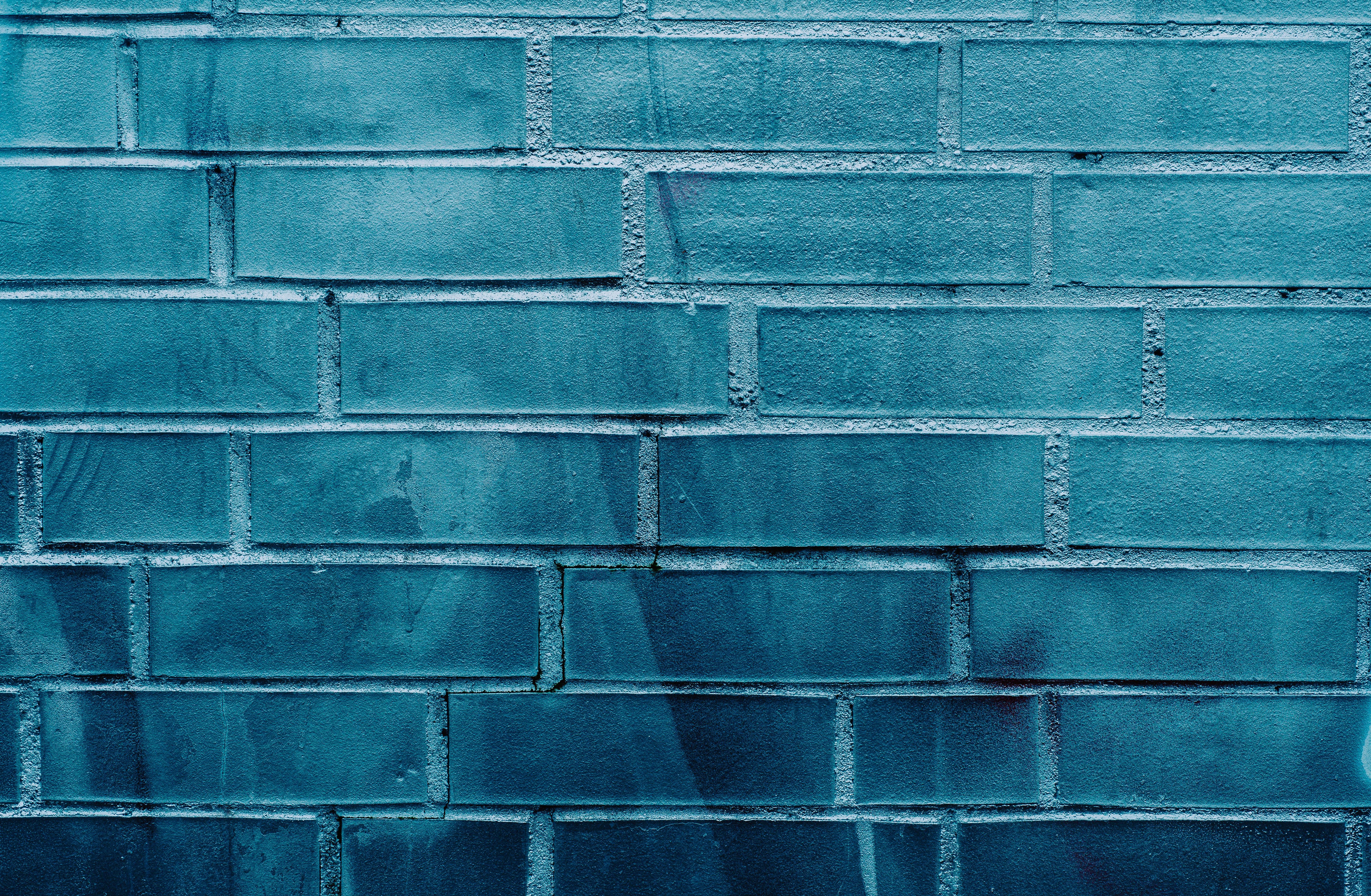 Free Close-up of a blue brick wall showcasing subtle graffiti textures and patterns. Stock Photo