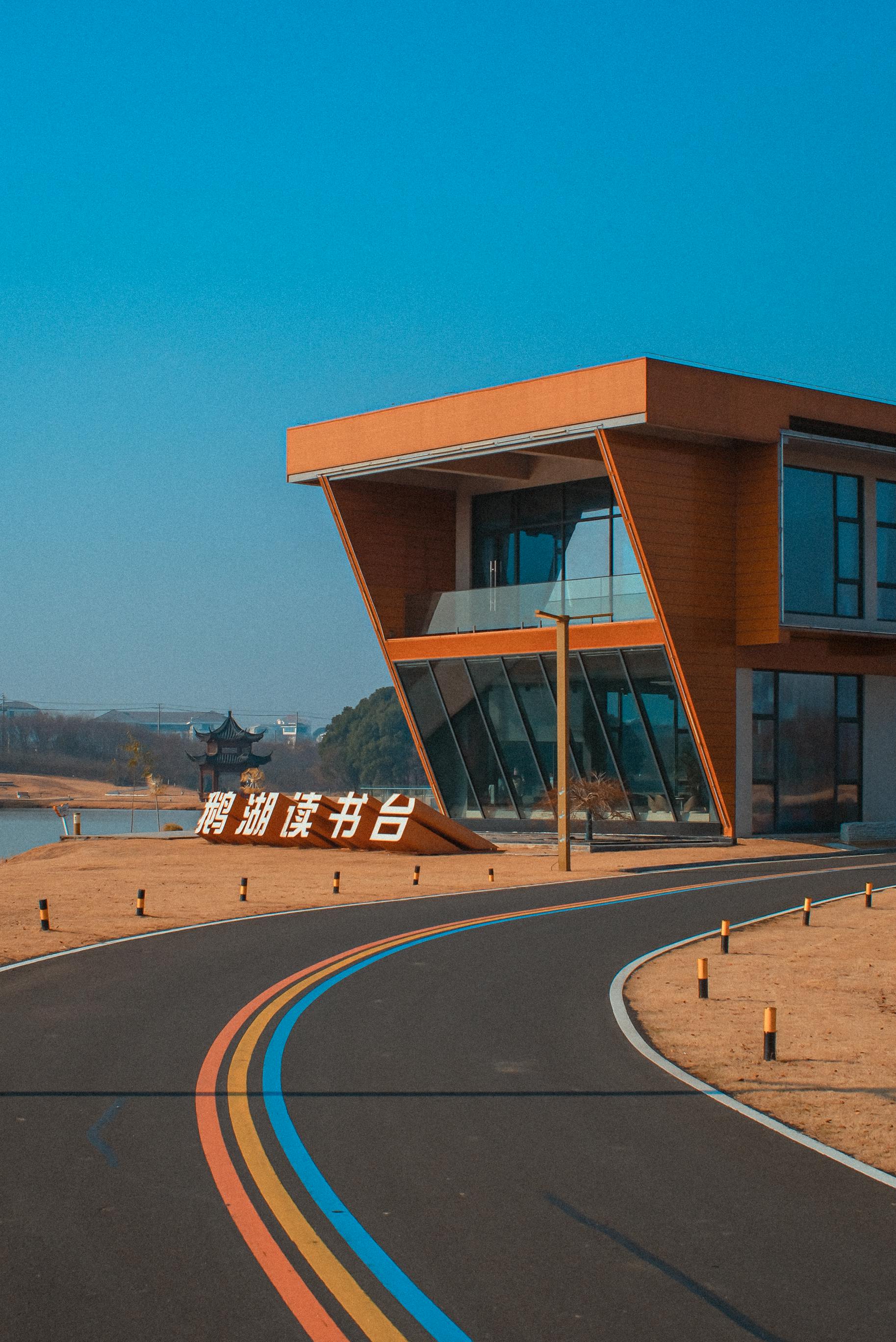 Modern Lakeside Building with Vibrant Roadway