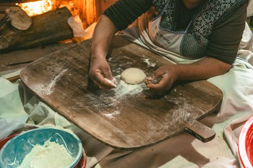 Free A traditional scene of Turkish bread making by a fireplace indoors. Stock Photo