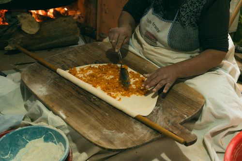 Free Woman prepares traditional Turkish borek with filling on dough indoors. Stock Photo