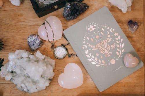 Free Pink Crystals Near A Notebook Stock Photo