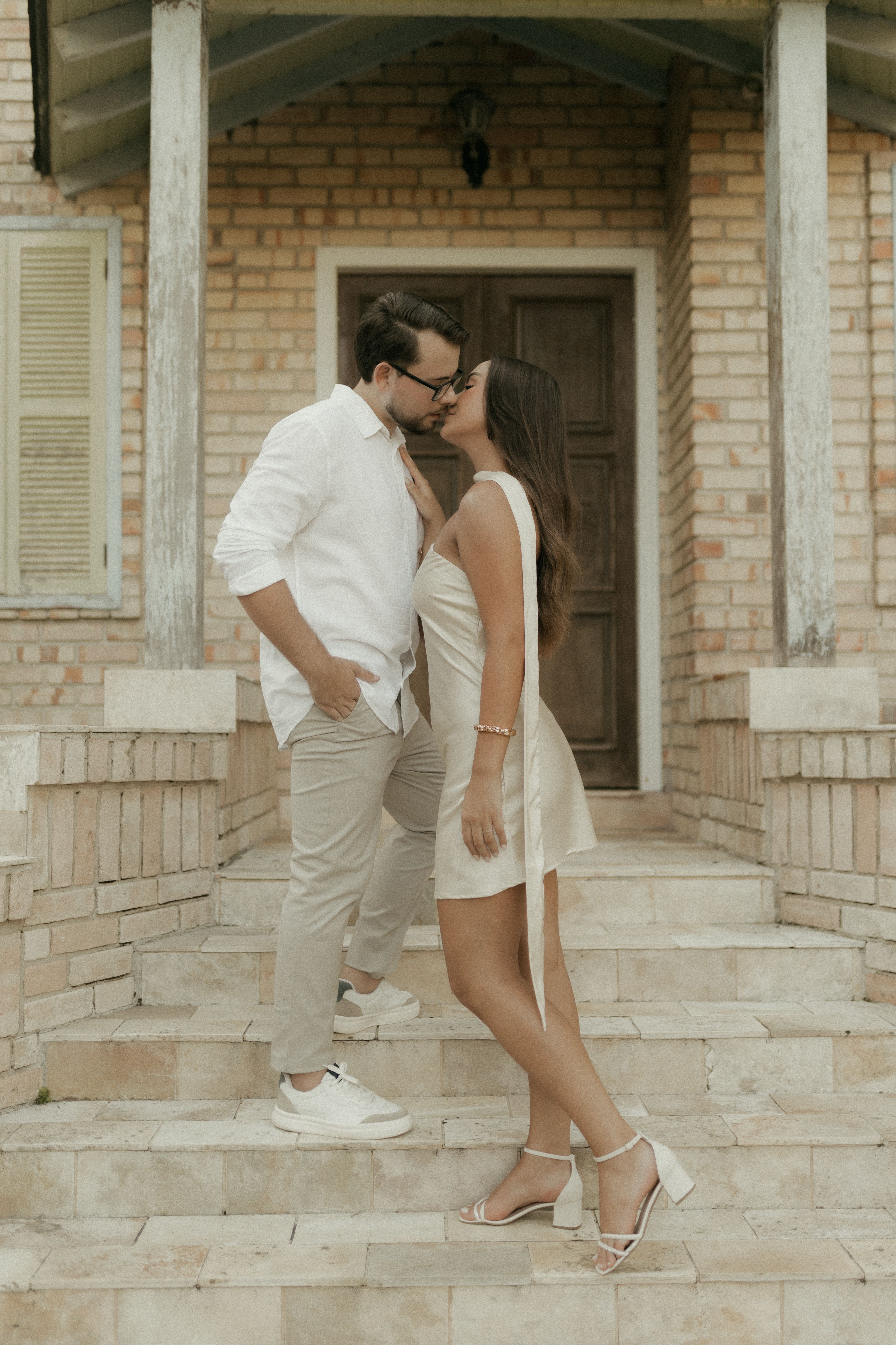 Romantic Couple Sharing a Kiss on Stone Steps · Free Stock Photo
