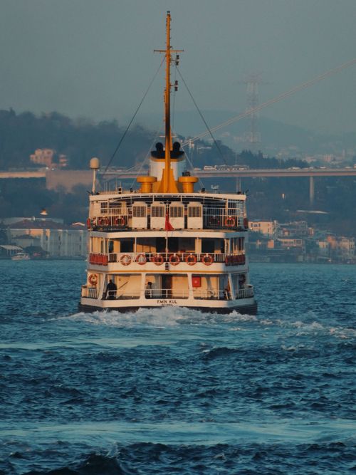 Free A ferry navigates the Bosphorus in Istanbul, capturing a bustling day with a view of the city in the background. Stock Photo