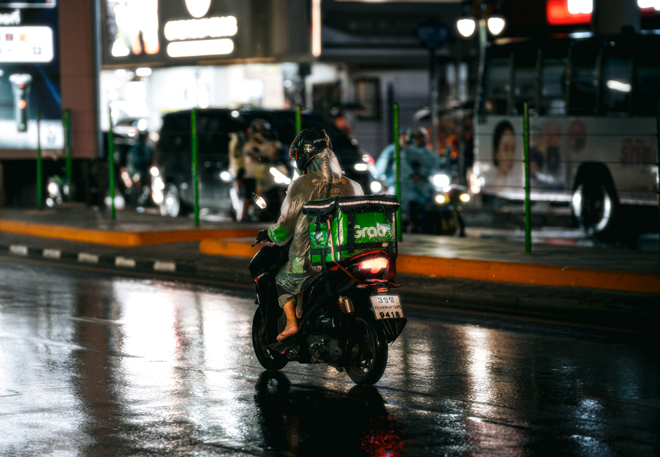 A Grab car waiting for passengers in a busy street in Bangkok, Thailand