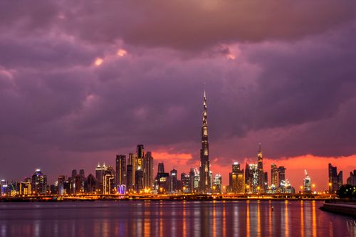 Free Stunning sunset view of Dubai skyline featuring the iconic Burj Khalifa. Stock Photo