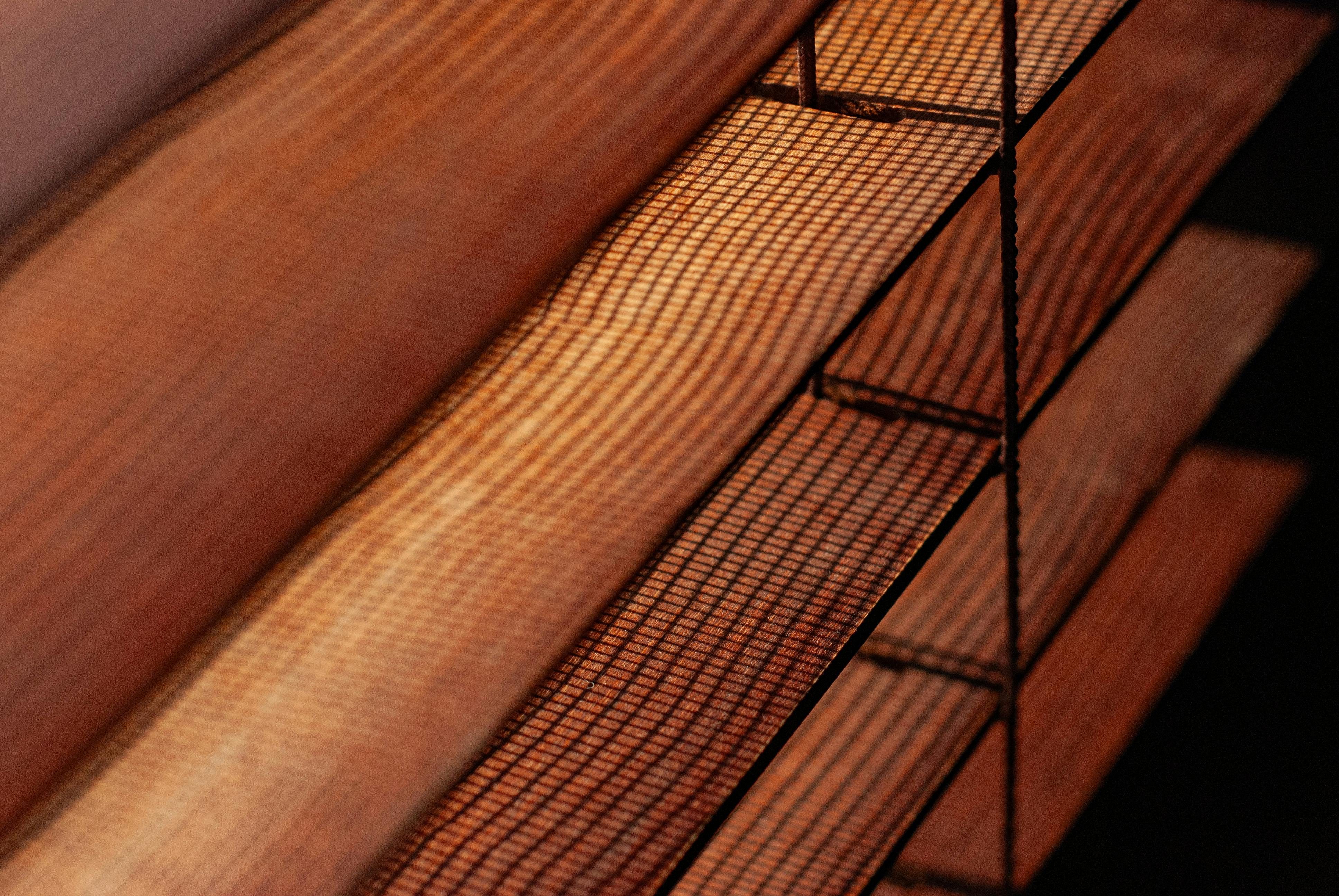 Free Detailed view of brown mesh blinds with warm lighting, creating a cozy indoor ambiance. Stock Photo