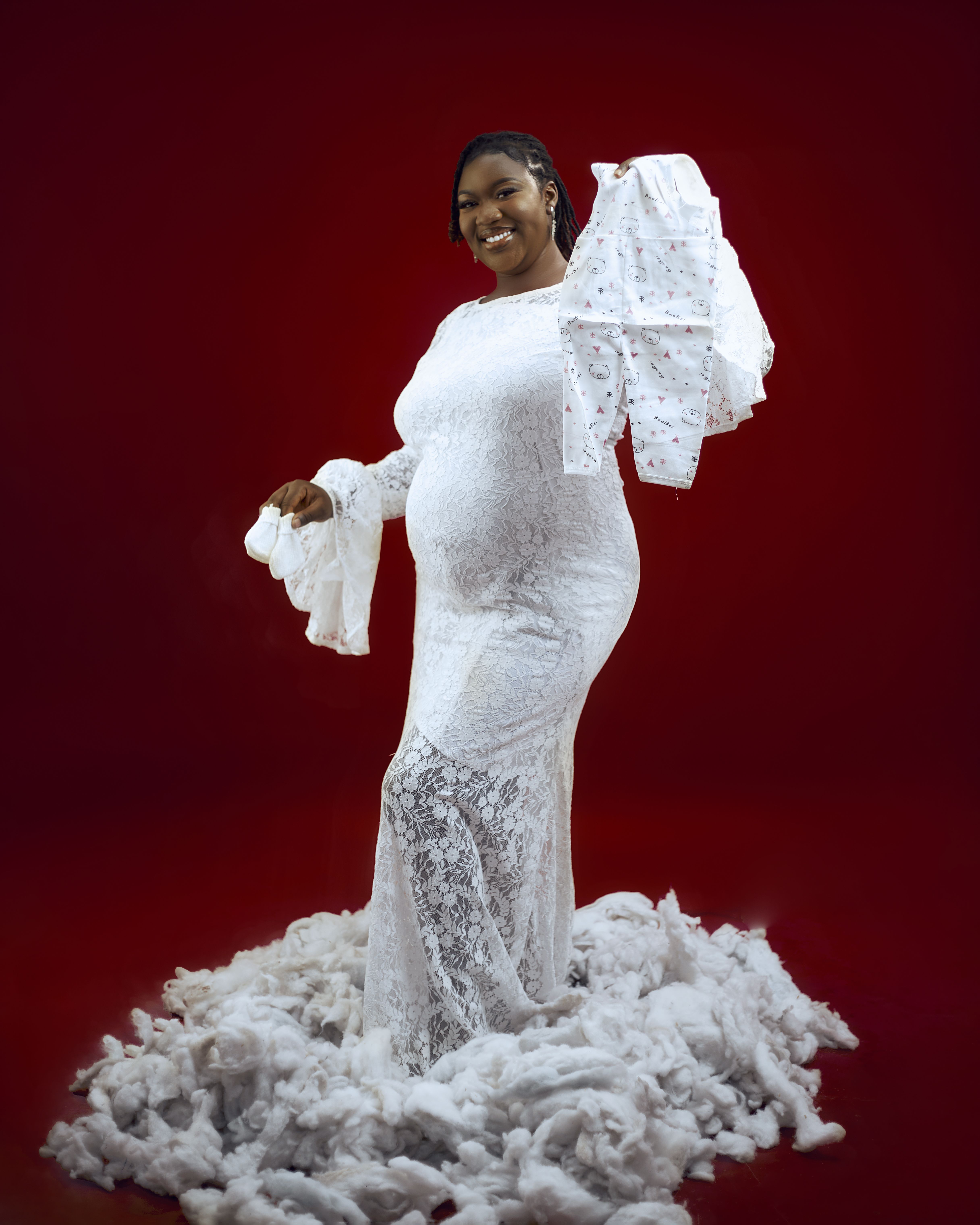Pregnant Woman in Elegant White Gown on Red Background  Free Stock Photo