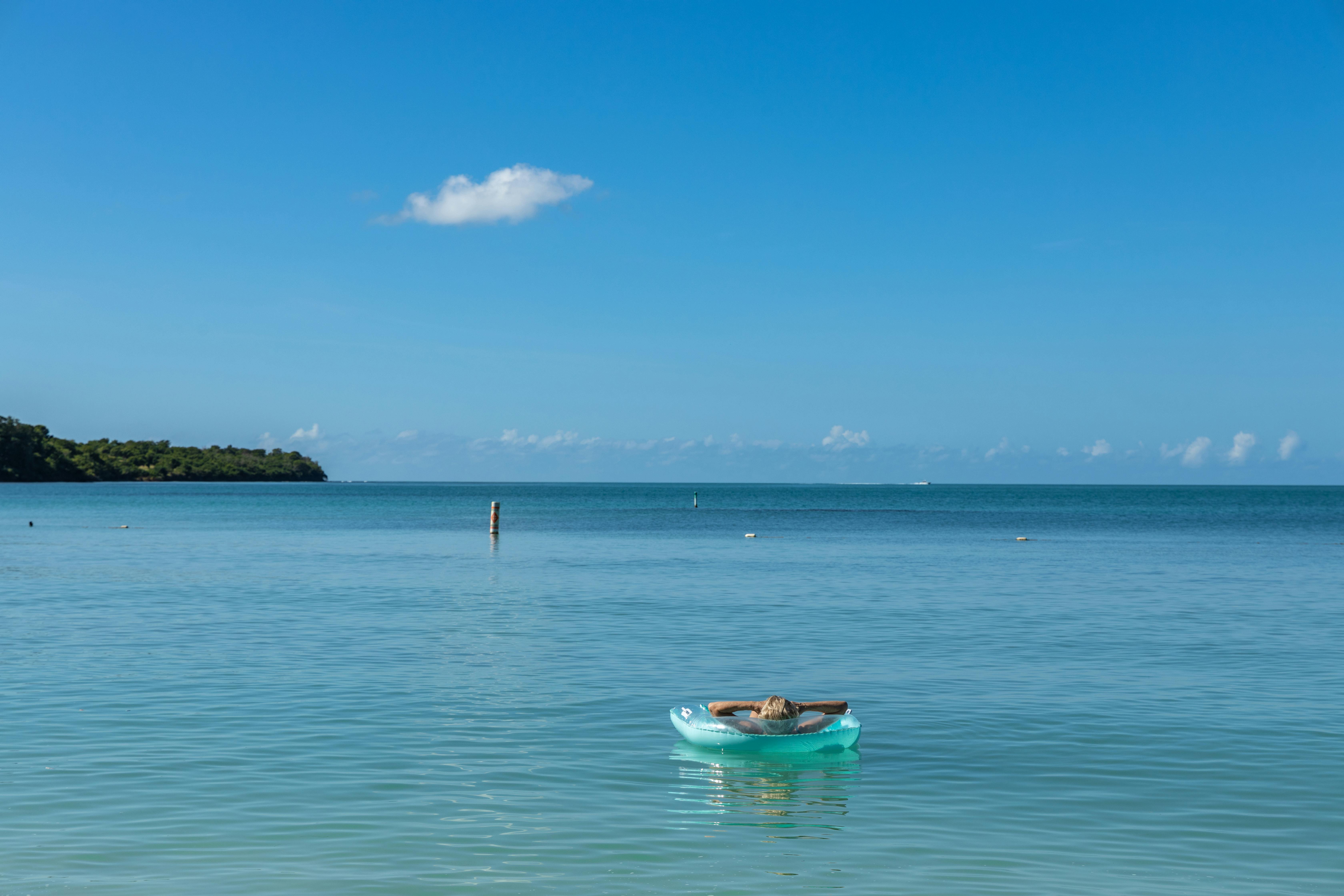 Peaceful ocean scene with a woman relaxing in a buoy at Cabo Rojo, Puerto Rico.