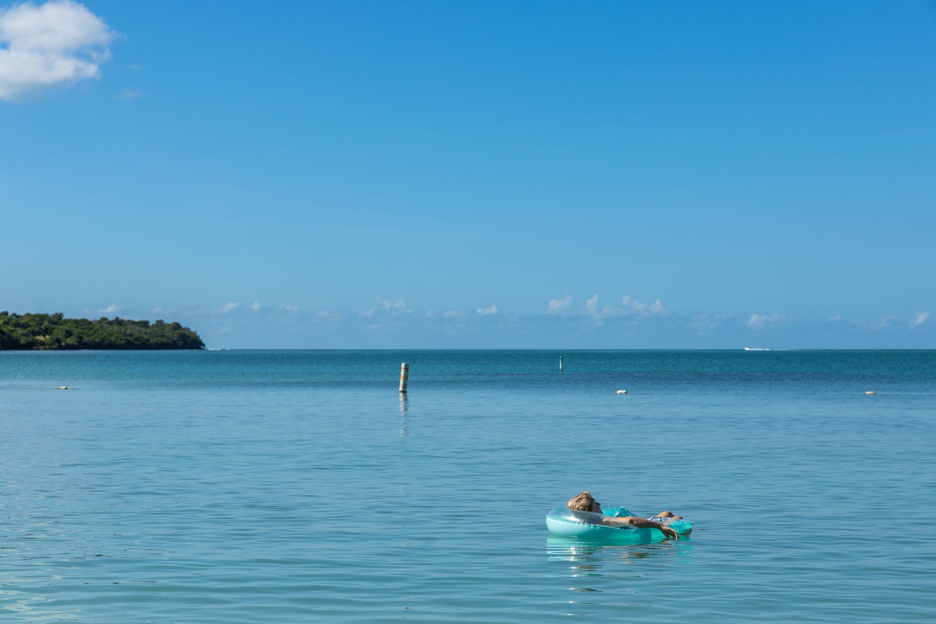 A tranquil scene of a woman relaxing on a float in the beautiful turquoise waters of Cabo Rojo, Puerto Rico.
