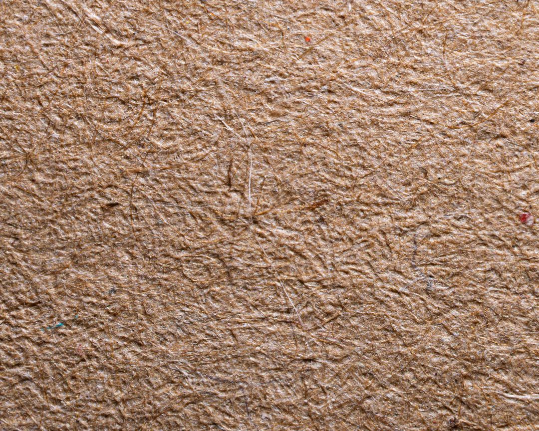 Close-up of brown recycled paper texture with visible fibers.