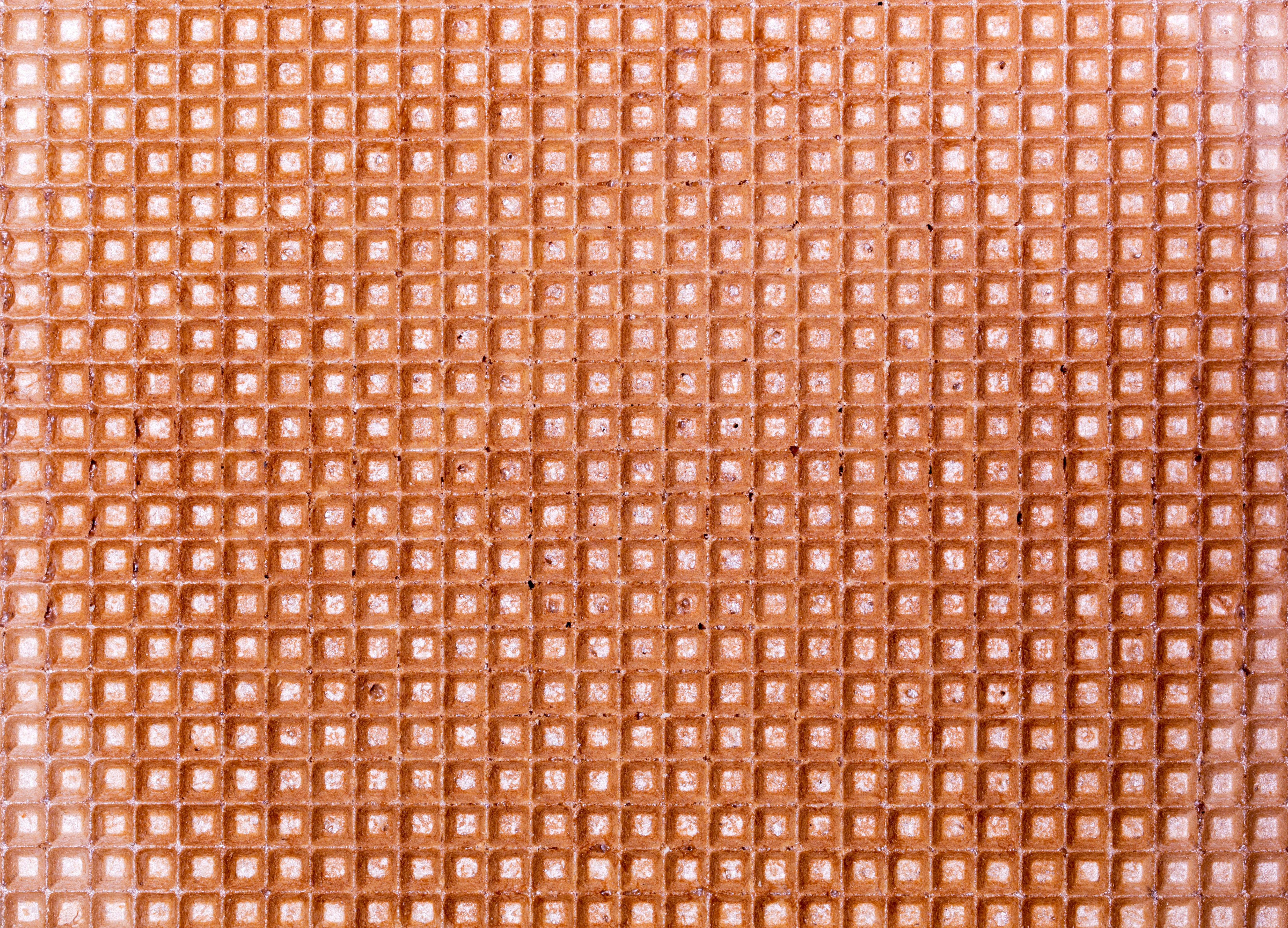 gratis Een gedetailleerde close-up van een wafelstructuur met een rasterpatroon, geschikt als achtergrond. Stockfoto