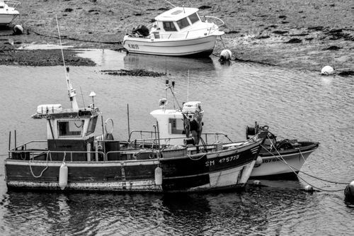 Free Monochrome view of fishing boats at low tide on Brittany's coastline. Stock Photo