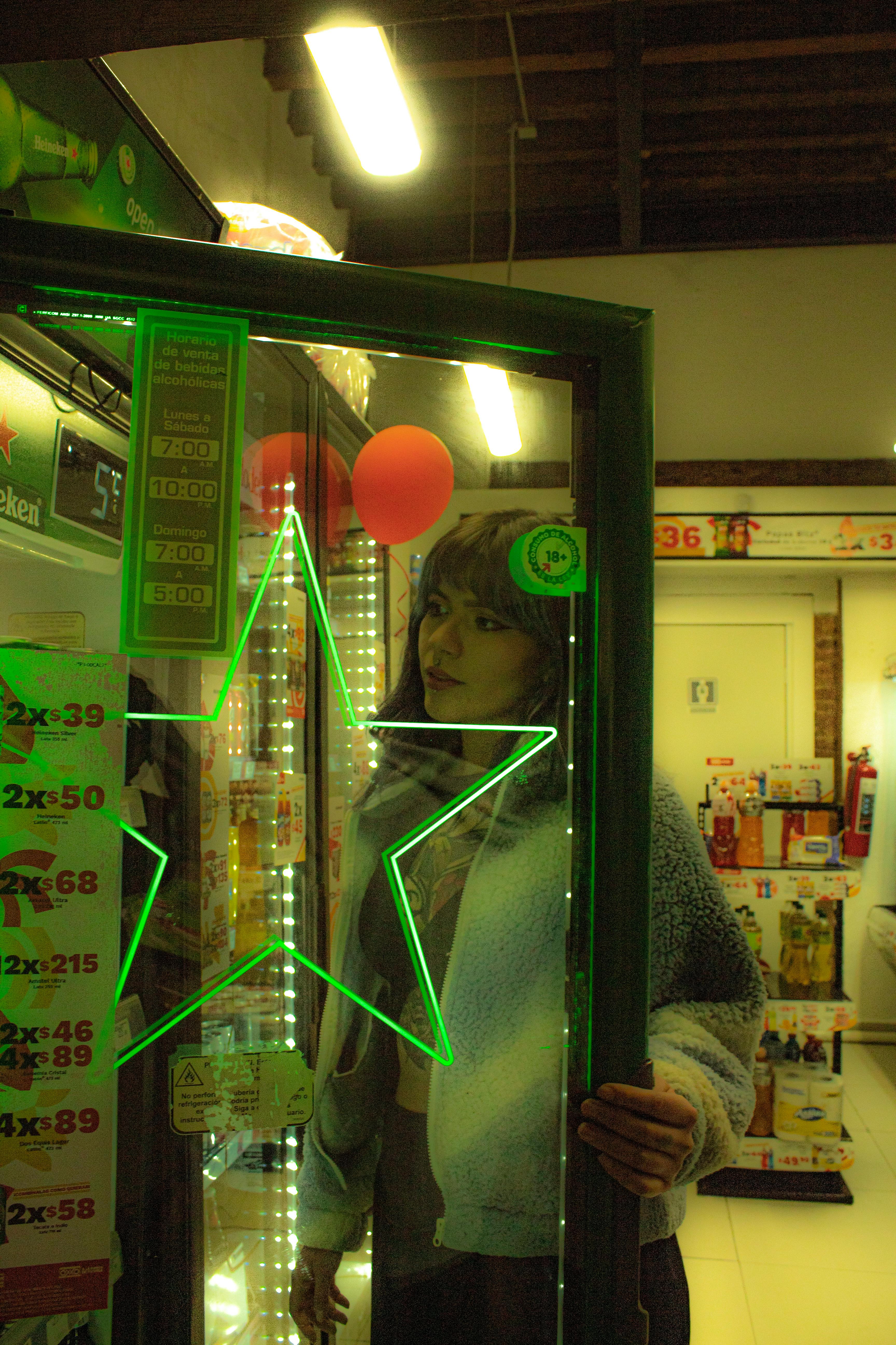 Woman at Convenience Store Fridge with Neon Light