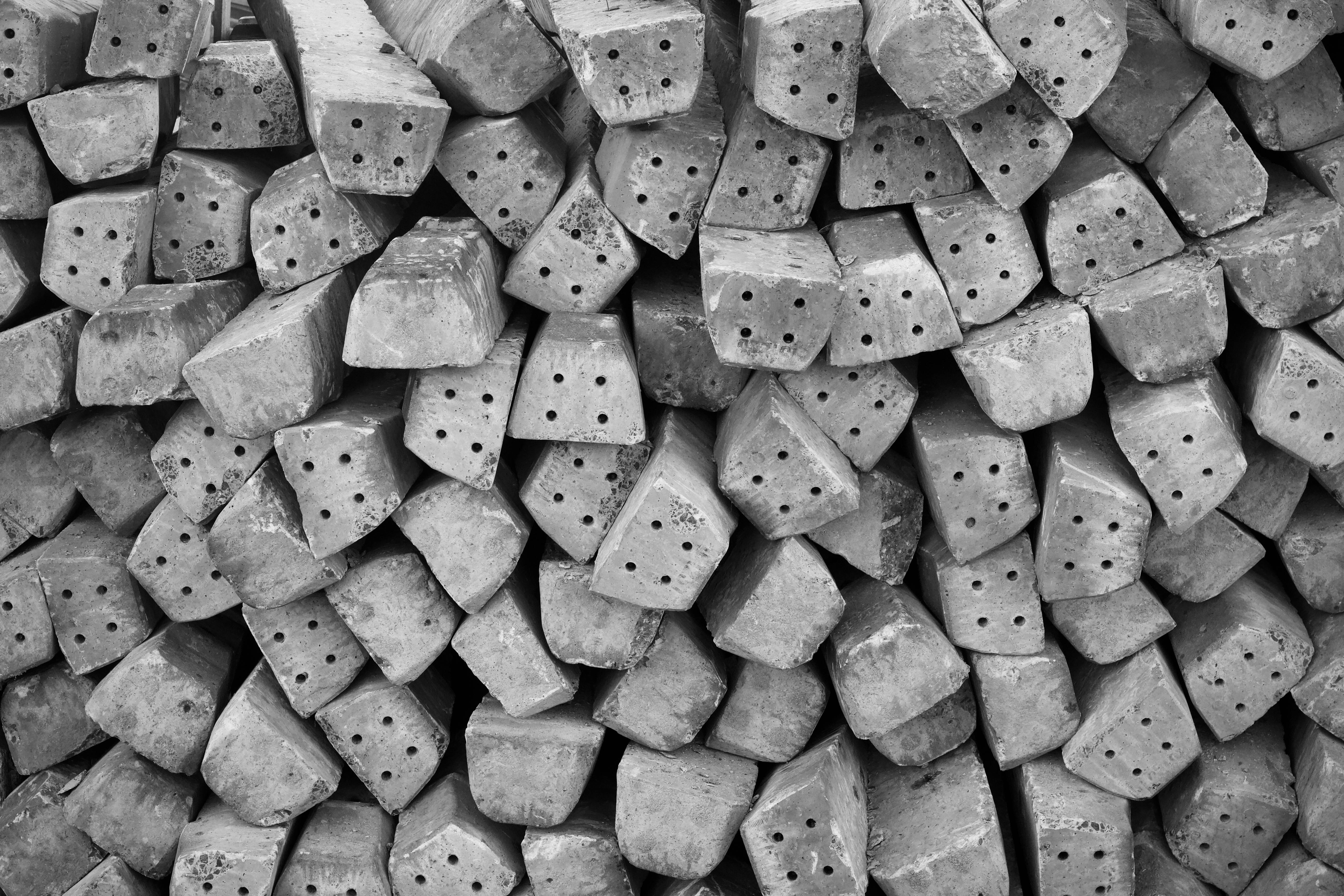 Free Monochrome image of stacked concrete blocks showing textures and patterns. Stock Photo