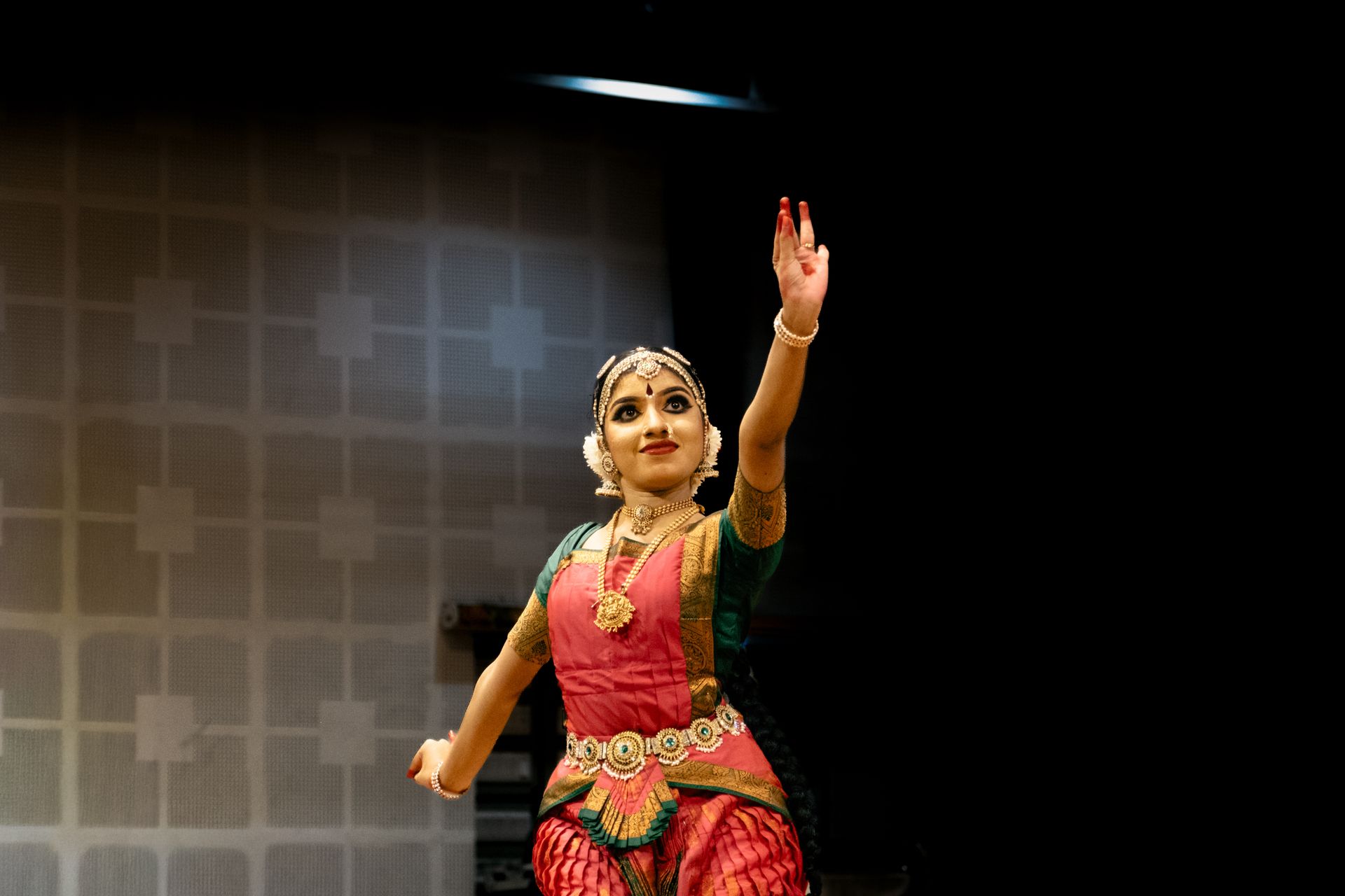 Bharatanatyam dancer in traditional attire performing on stage
