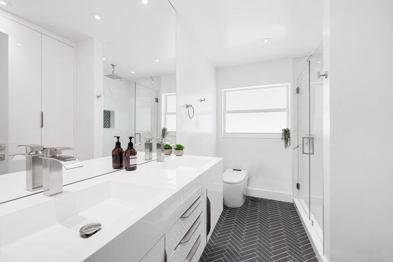 Spa-like modern bathroom with freestanding tub and herringbone tile