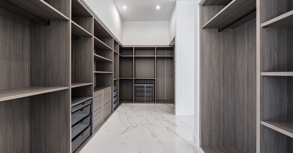 Elegant walk-in closet with ample shelving and storage in a modern design.