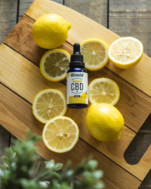 Lemon Fruit Beside CBD Black Bottle