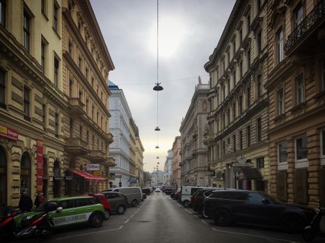 Explore the classic architecture and urban street atmosphere of Vienna on this overcast day.