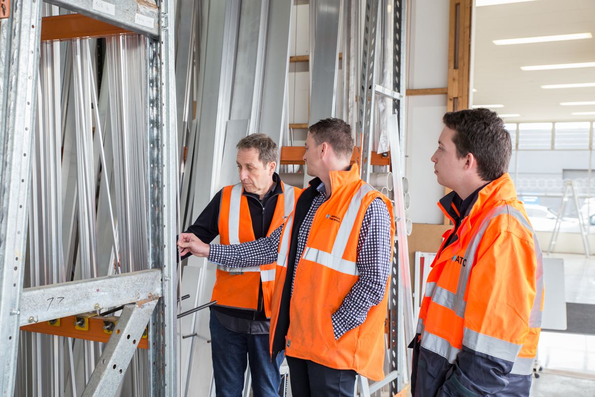 Construction professionals inspecting structural materials