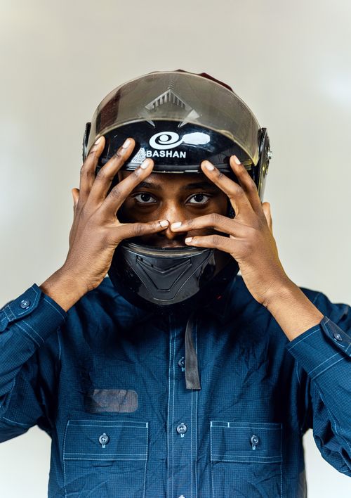 Free Focused motorcyclist adjusting helmet, ensuring safety and protection. Stock Photo