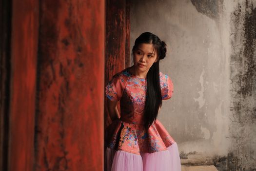 Portrait of a young woman wearing traditional Vietnamese attire in Hanoi, Vietnam.