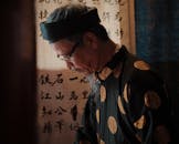 Elderly Vietnamese Calligrapher in Traditional Attire