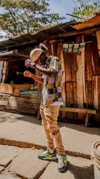 Stylish young man poses in Nairobi, embracing urban street fashion with a colorful flair.