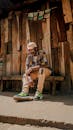 Stylish Man in Streetwear Resting on Wooden Bench in Nairobi