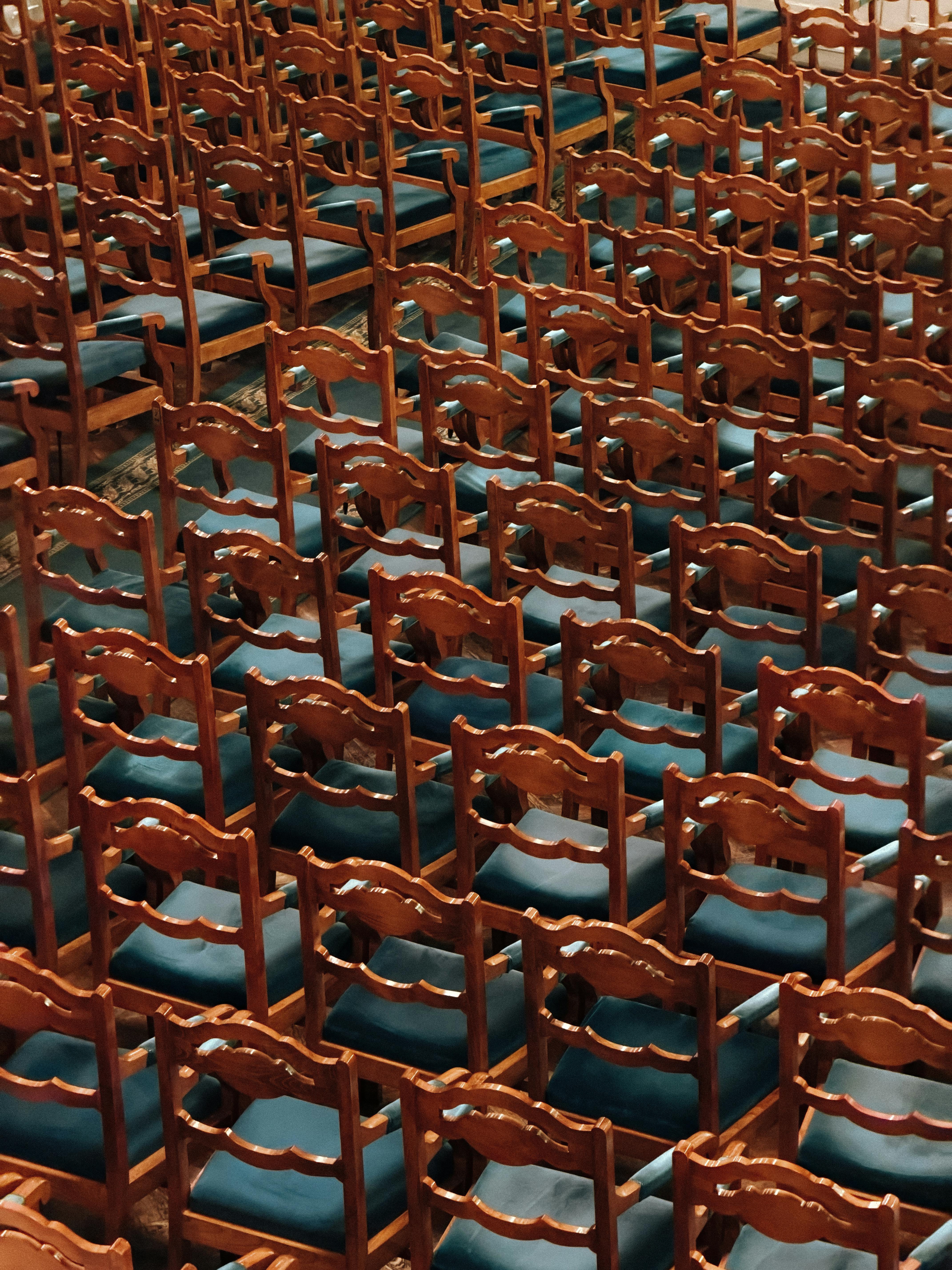Free Rows of elegant wooden chairs with teal cushions in a historic St. Petersburg cathedral. Stock Photo