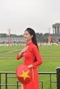 Vietnamese Woman in Traditional Ao Dai at Landmark