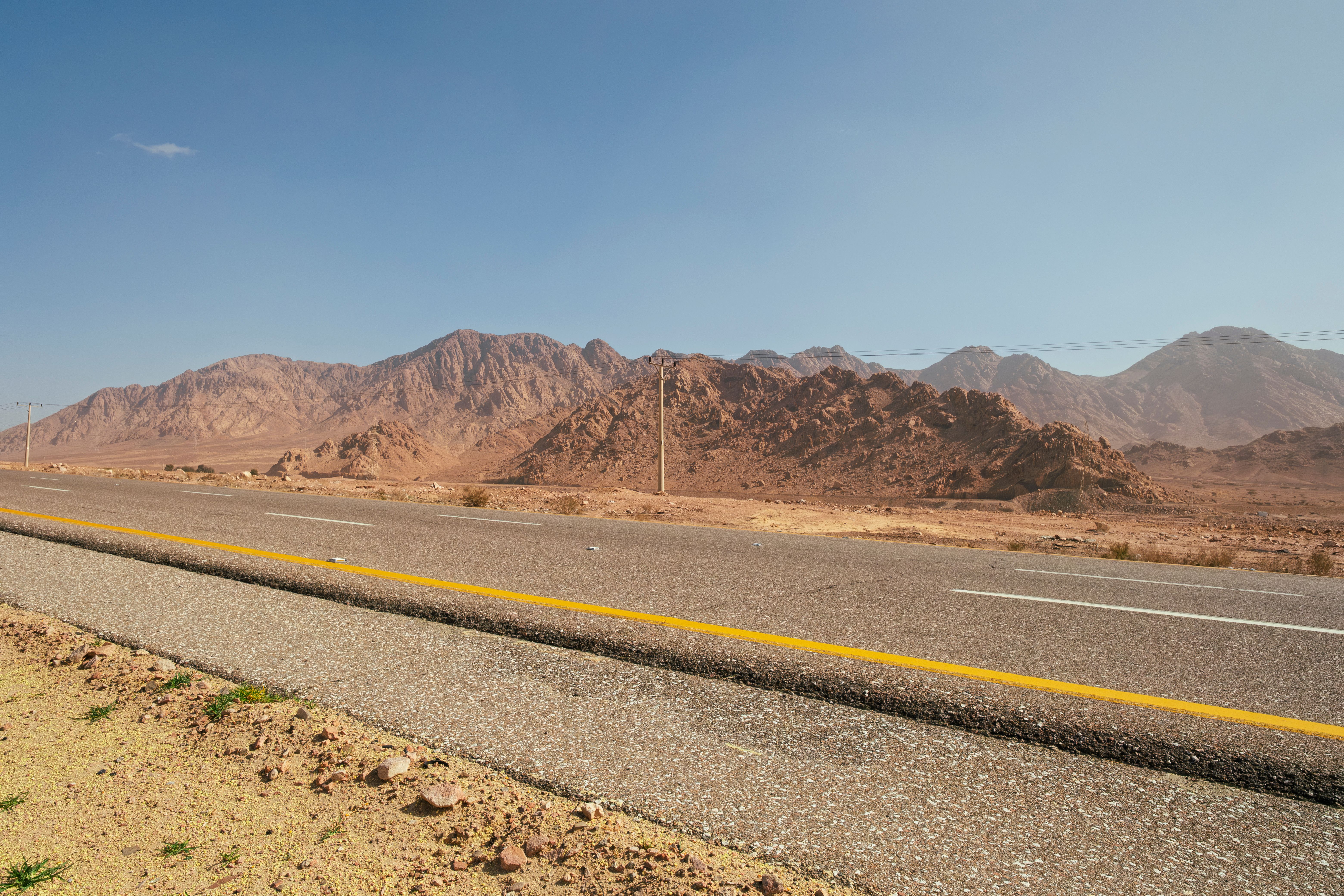 A deserted road stretches through the rocky mountains of Aqaba, offering breathtaking views and solitude. - Aqaba