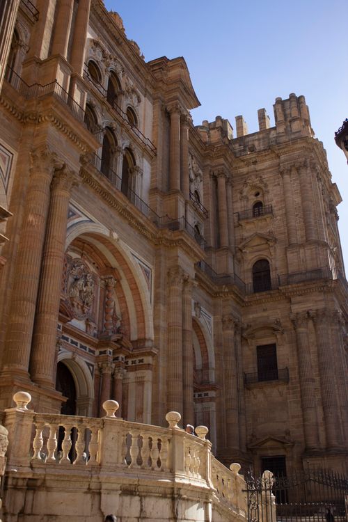 Free A striking view of the Baroque facade of the historic Málaga Cathedral against a clear blue sky. Stock Photo