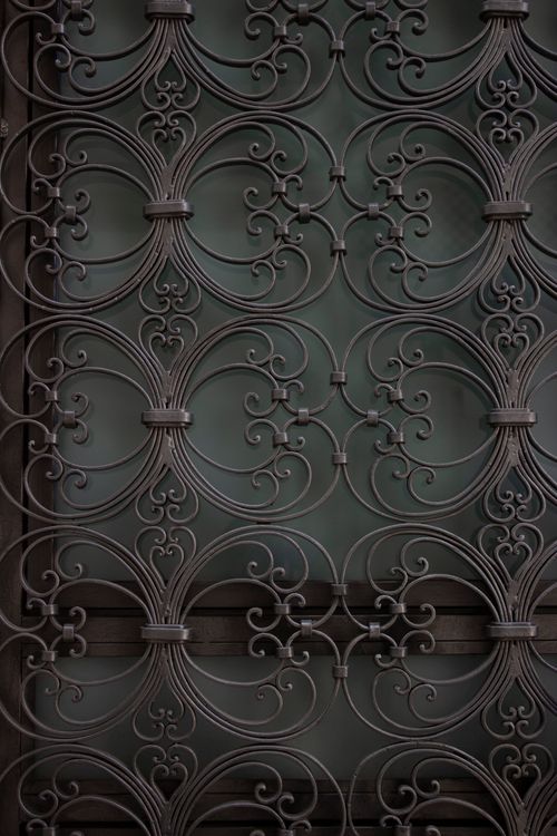Free Close-up of intricate iron scrollwork on a building facade in Málaga, Andalucía. Stock Photo