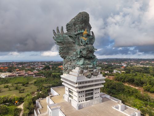 Free Stunning aerial shot of the Garuda Wisnu Kencana statue in Bali, under dramatic skies. Stock Photo