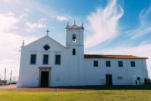Free Historic white church with bell tower against a clear blue sky. Stock Photo