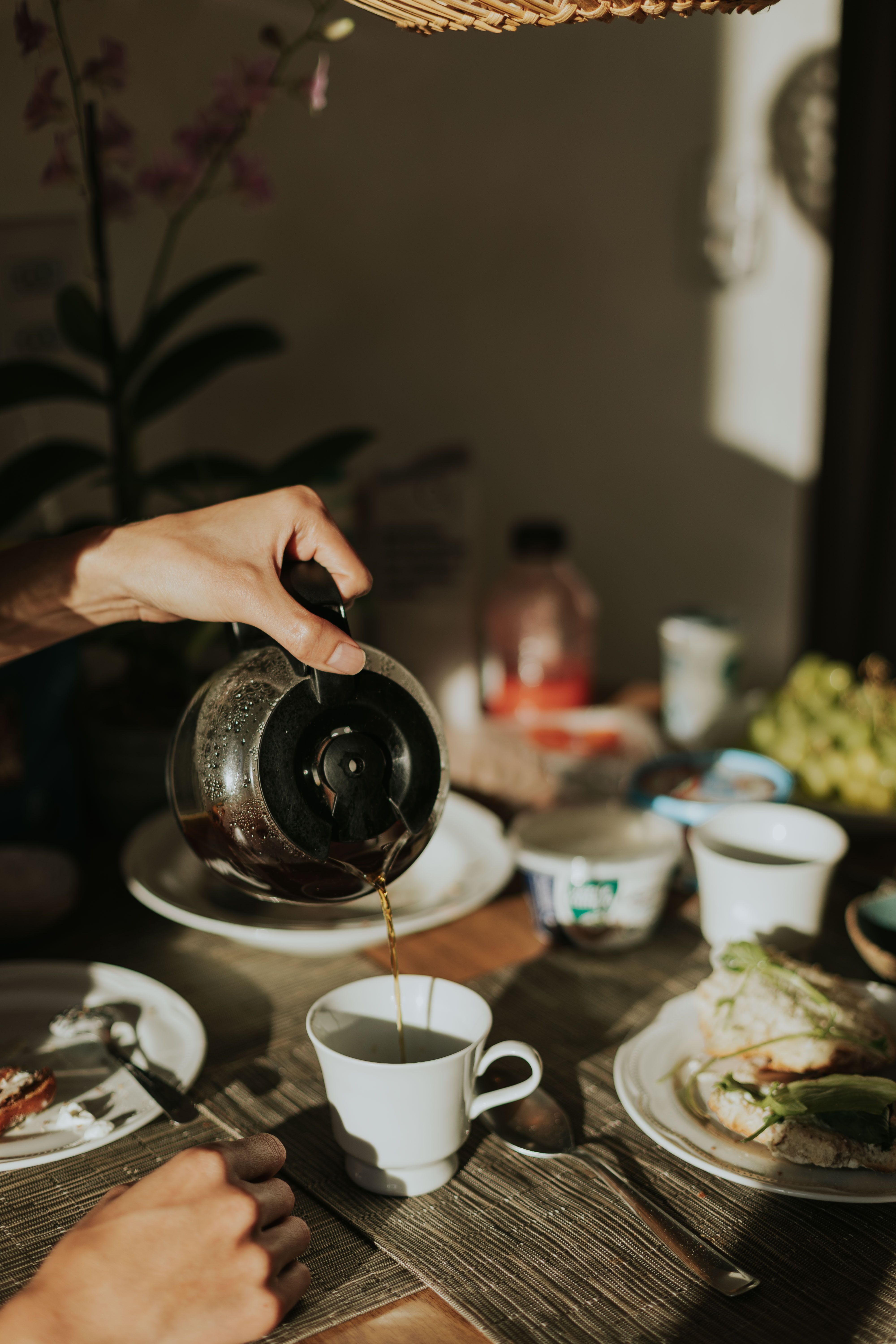 Morning breakfast scene with coffee and food on the table.