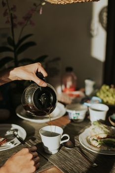 Morning breakfast scene with coffee and food on the table.