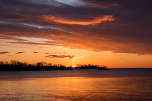 Free Captivating winter sunrise over Cove Island Park in Stamford, Connecticut, reflecting vibrant hues over tranquil waters. Stock Photo