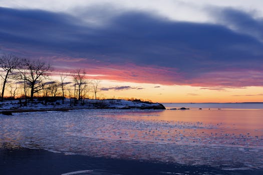 Serene winter sunrise over frozen Cove Island Park in Stamford, Connecticut, capturing icy reflections and colorful skies.