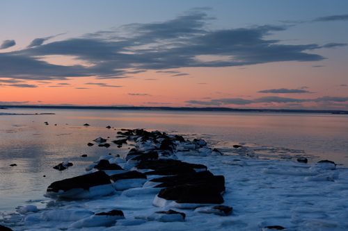 Free Beautiful winter sunrise over icy rocks at Cove Island Park, Stamford, Connecticut. Stock Photo