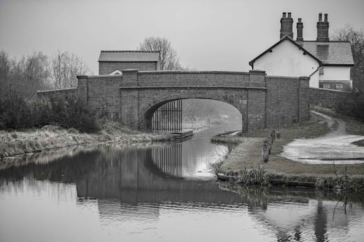 Black and white view of a historic canal bridge in Pelsall, England.