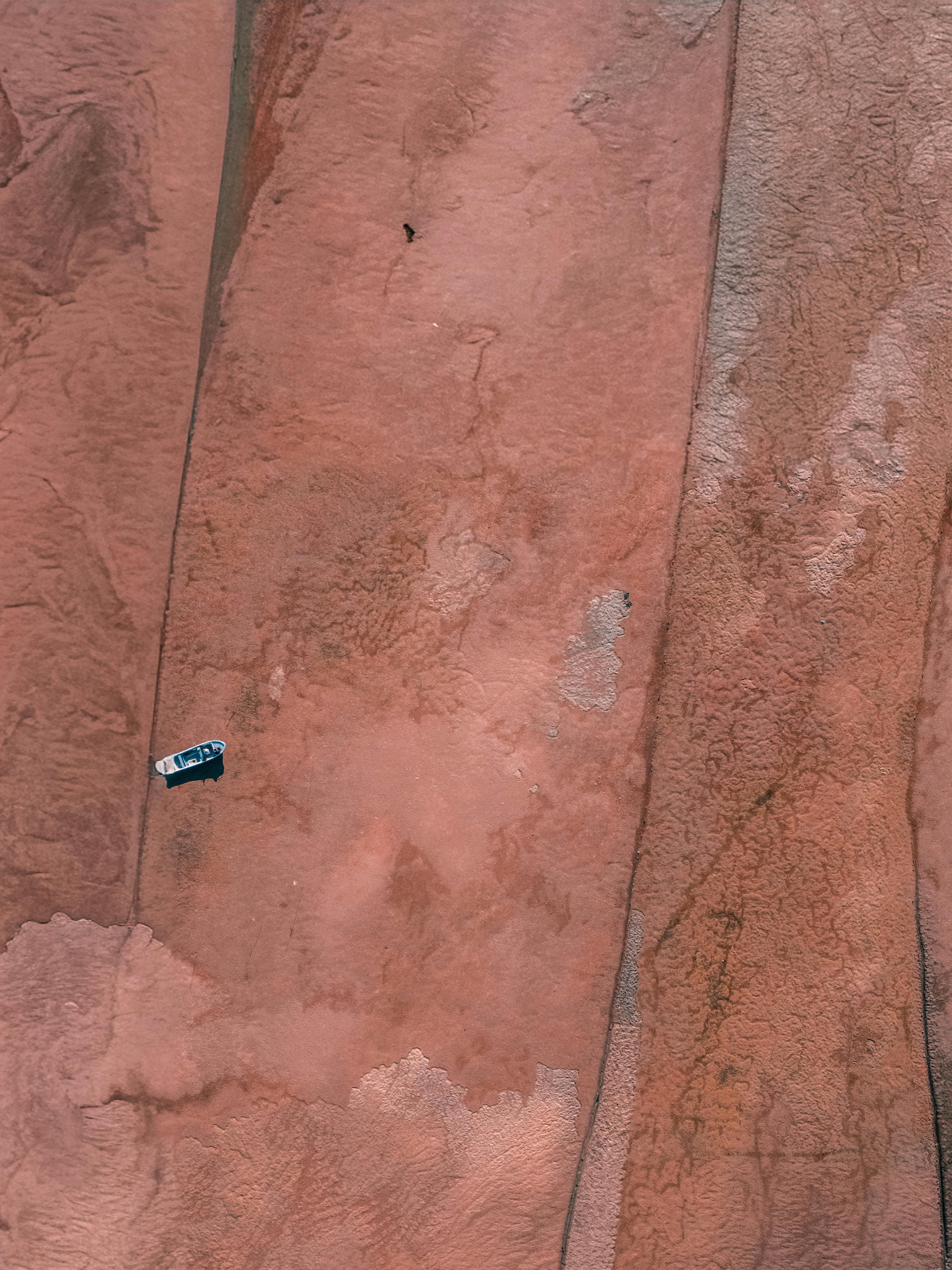 Free Aerial photo showcasing a van on rugged terrain in Olhão, Portugal. Ideal for travel and adventure themes. Stock Photo