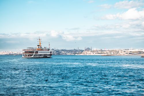 Free Scenic view of a ferry crossing the Bosphorus with Istanbul skyline in the background. Stock Photo