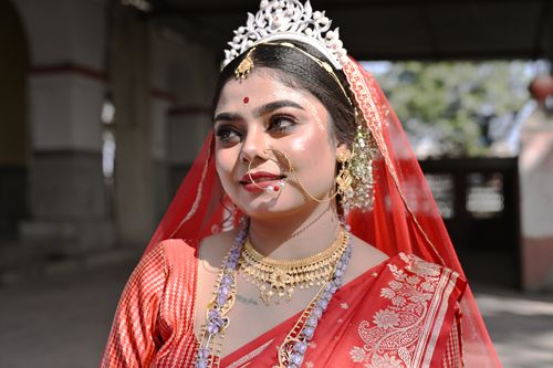 Free Beautiful Bengali bride in traditional red saree and jewelry during an outdoor wedding in Purulia, India. Stock Photo